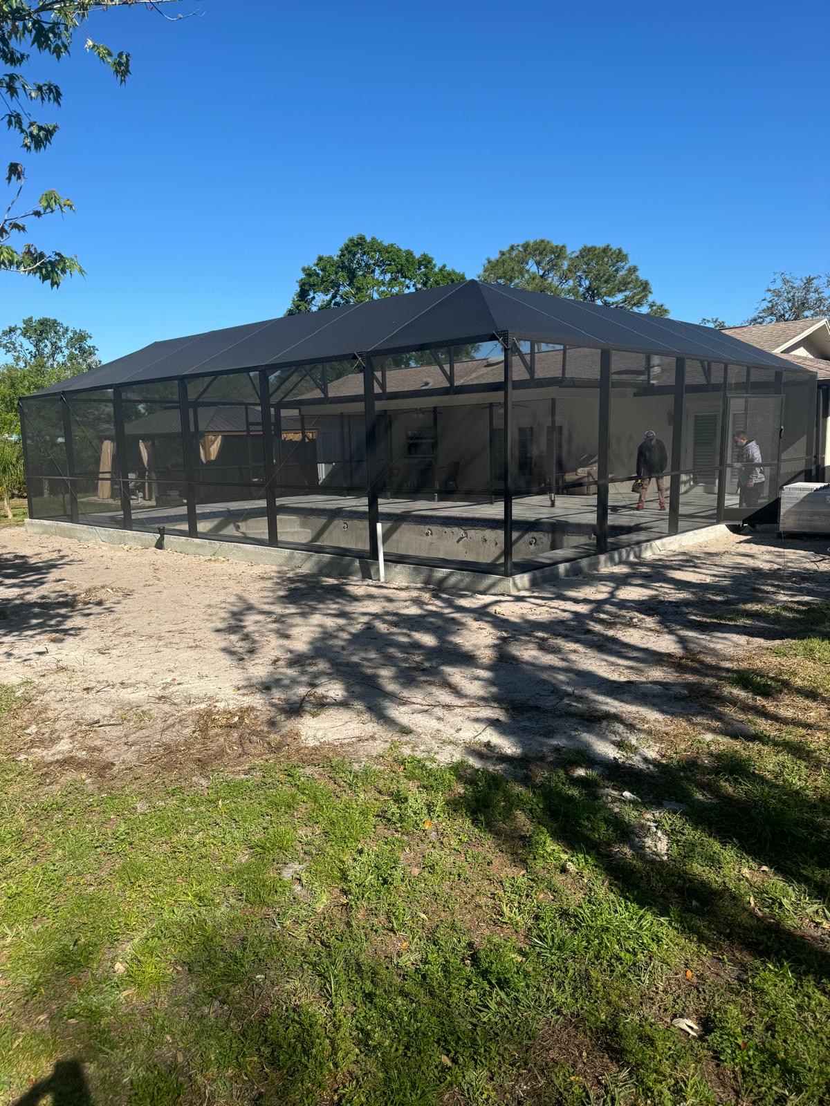 Black-framed aluminum pool enclosure over screened patio in Odessa, Florida