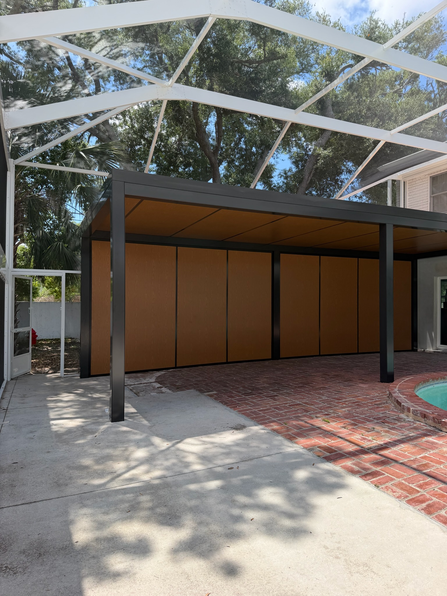 Modern aluminum carport with recessed lighting beside a pool in the Tampa Bay area, Florida